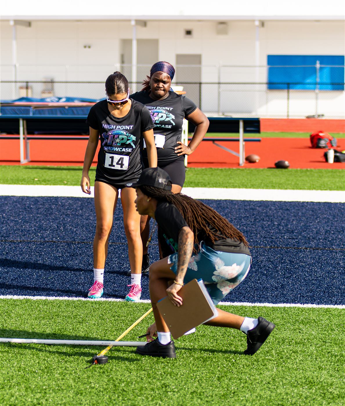 Coaches measuring an athlete's results